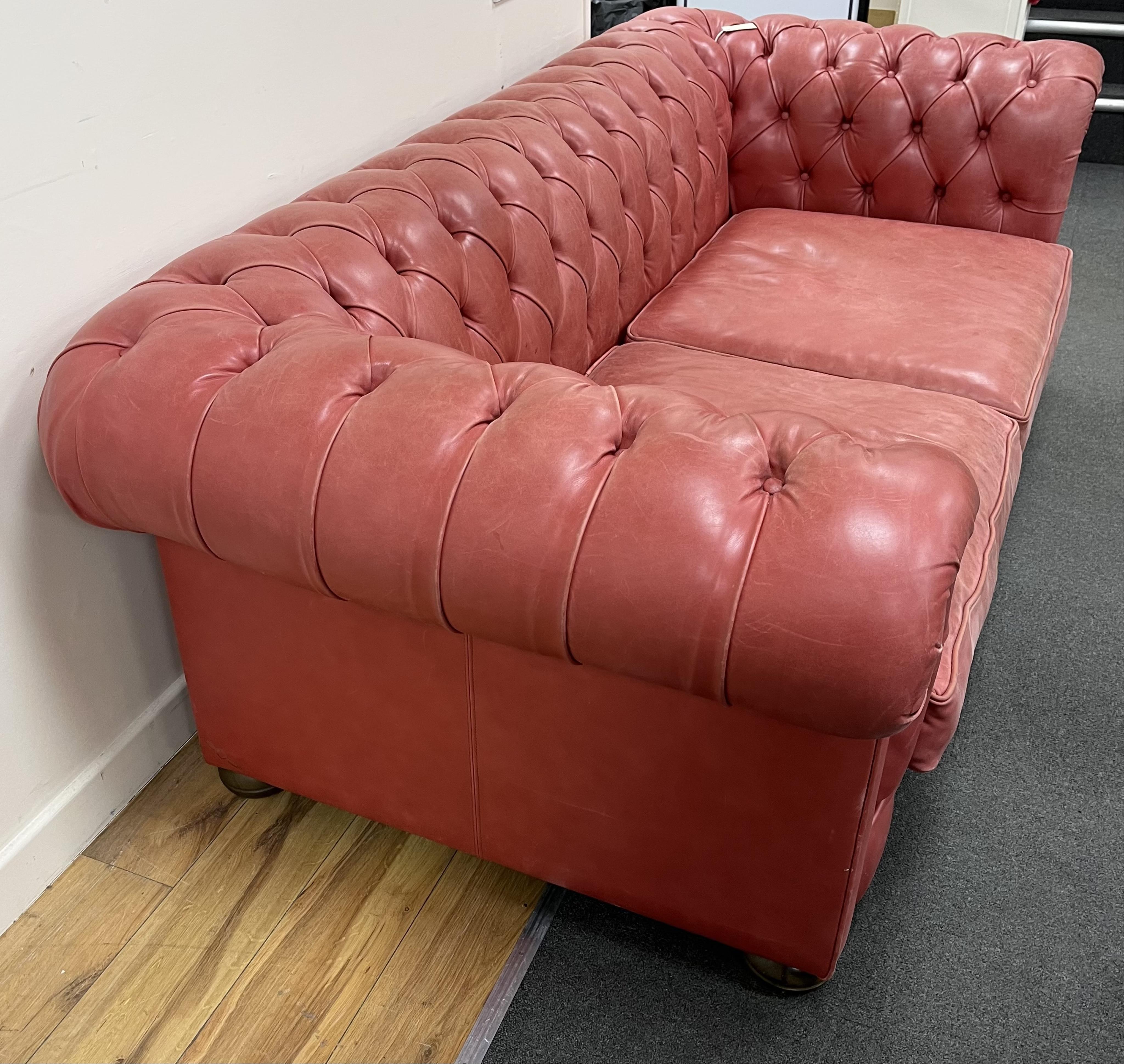 A Victorian style buttoned pale red leather Chesterfield settee, width 210cm, depth 104cm, height 71cm. Condition - fair to good